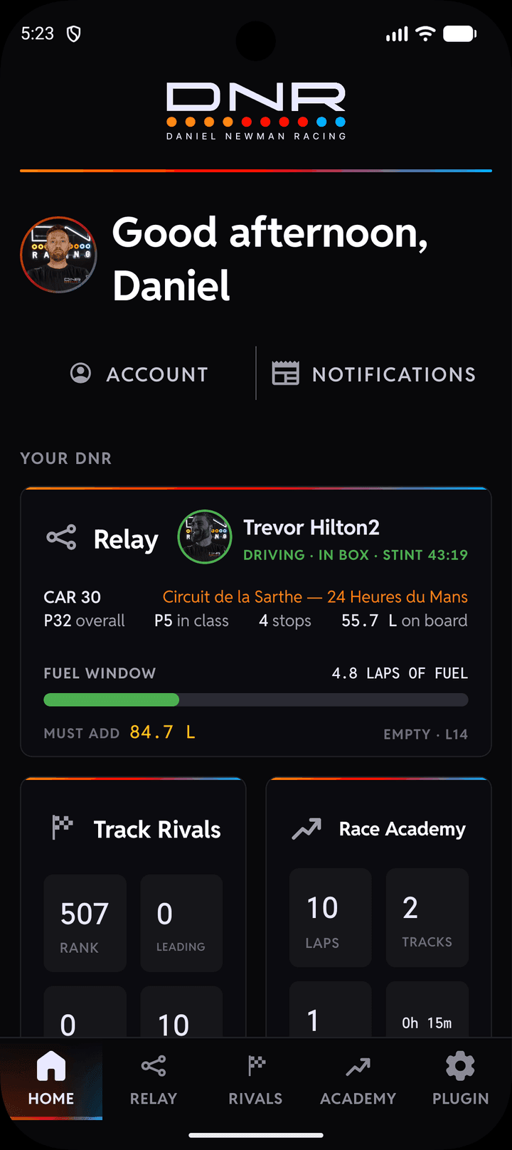 The DNR app on a phone: the Home page with a teammate driving on the Relay tile beside the Track Rivals and Race Academy tiles
